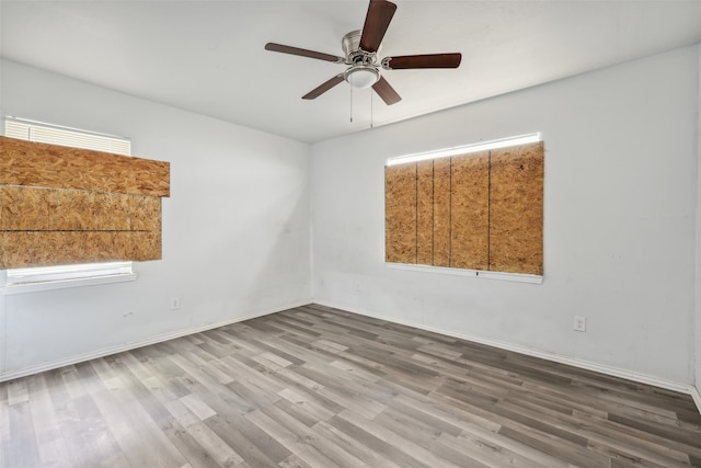 spare room featuring hardwood / wood-style flooring and ceiling fan