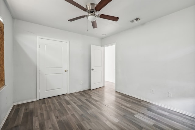 unfurnished bedroom with dark hardwood / wood-style floors and ceiling fan