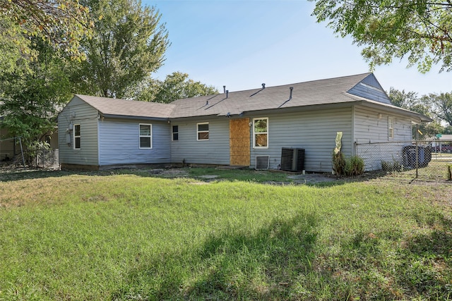 back of house with a yard and central air condition unit