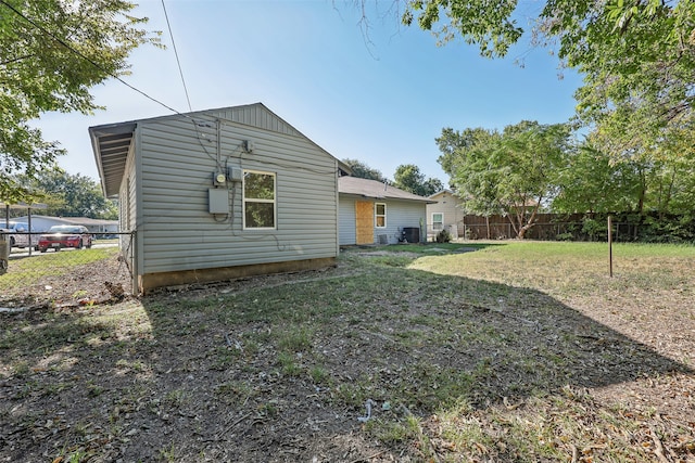 rear view of property with a yard