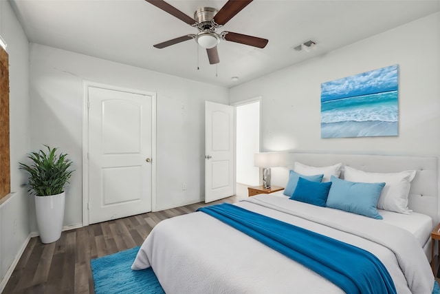 bedroom with ceiling fan and dark hardwood / wood-style flooring