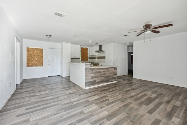 unfurnished living room featuring light hardwood / wood-style flooring and ceiling fan