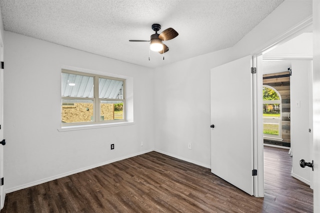 unfurnished bedroom featuring a textured ceiling, dark wood-type flooring, and ceiling fan