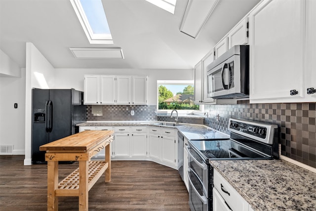 kitchen featuring dark hardwood / wood-style floors, sink, light stone countertops, white cabinetry, and appliances with stainless steel finishes