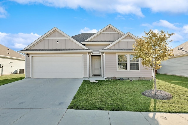 view of front of property featuring central air condition unit, a front yard, and a garage