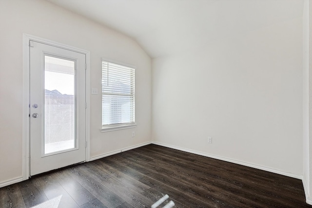 empty room with lofted ceiling and dark hardwood / wood-style flooring