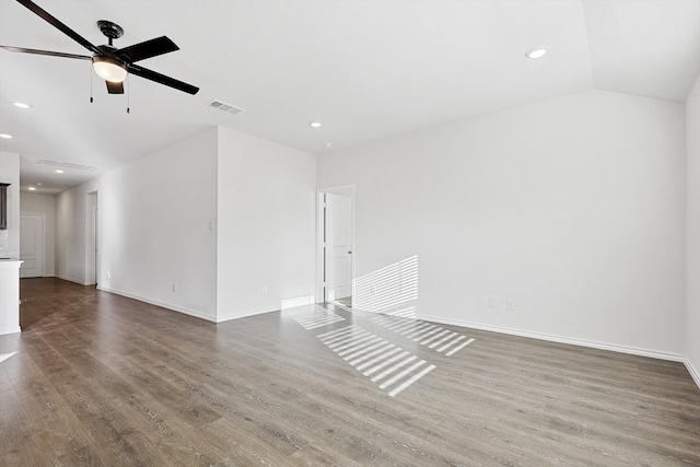 unfurnished room with hardwood / wood-style flooring, vaulted ceiling, and ceiling fan