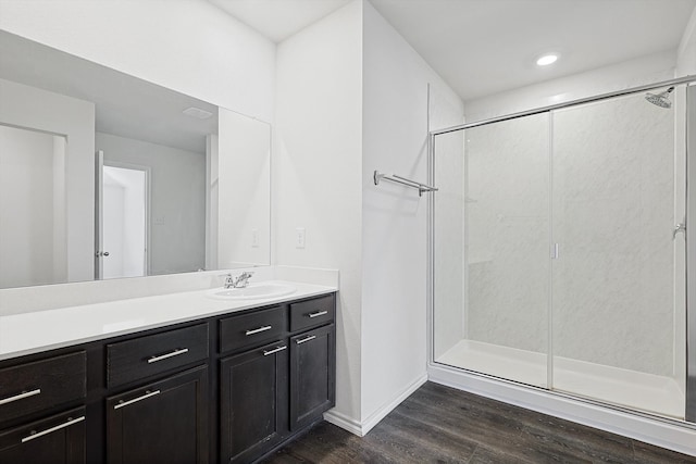 bathroom with vanity, wood-type flooring, and a shower with door