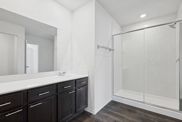 11120 W Pond Dr, Providence Village, TX 76227 - full bathroom with wood finished floors, a stall shower, vanity, baseboards, and recessed lighting