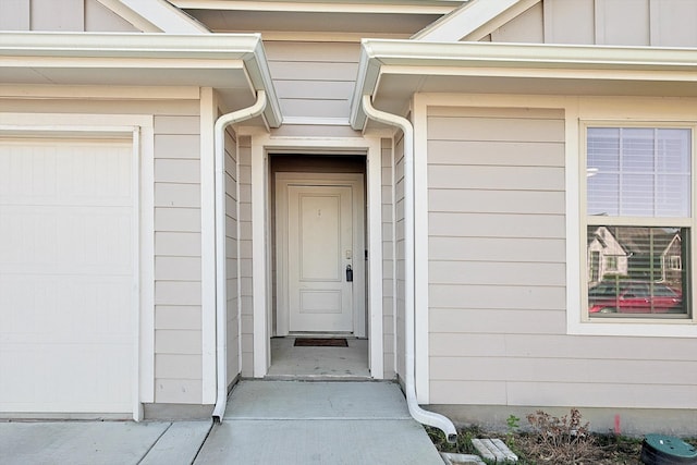 view of exterior entry with a garage