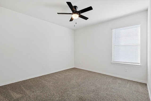 carpeted empty room with a healthy amount of sunlight and ceiling fan