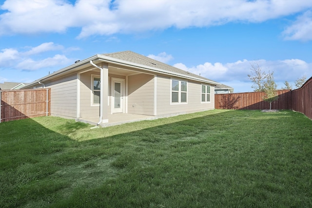 rear view of house featuring a patio area and a lawn