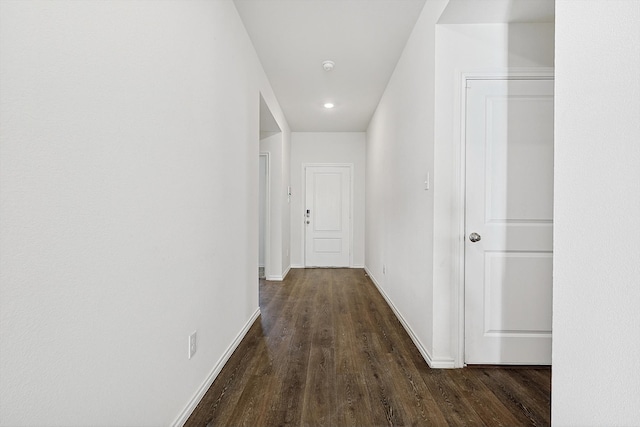 corridor featuring dark wood-type flooring