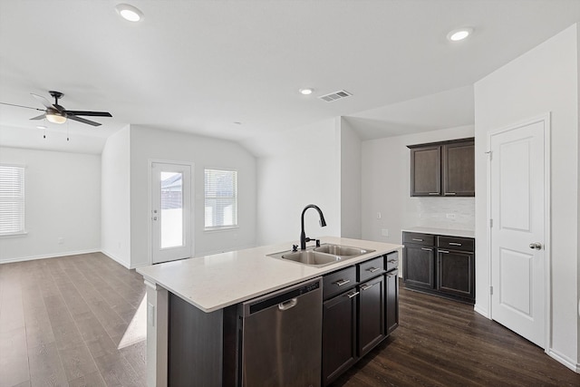 kitchen featuring sink, dishwasher, ceiling fan, dark wood-type flooring, and a center island with sink