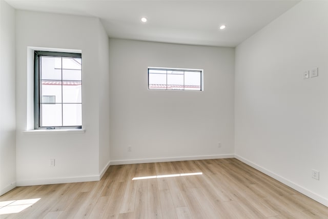 unfurnished room with light hardwood / wood-style flooring and plenty of natural light