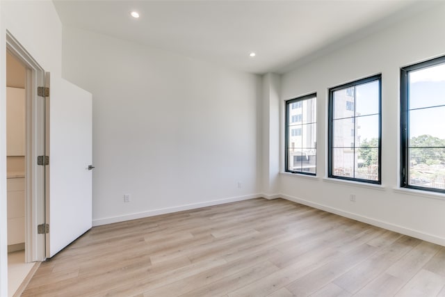 unfurnished room with light hardwood / wood-style floors