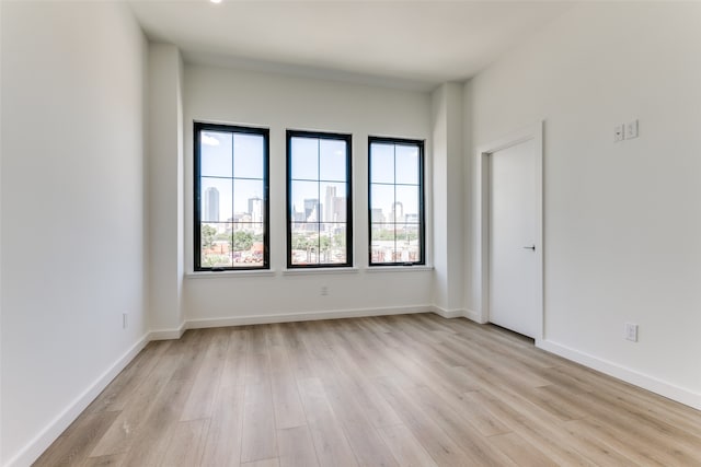 spare room with light wood-type flooring