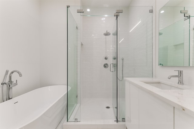 bathroom featuring vanity and shower with separate bathtub