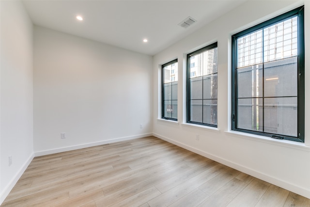 unfurnished room with light hardwood / wood-style floors