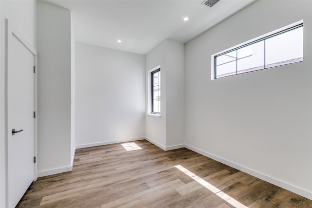 unfurnished room with light hardwood / wood-style floors and plenty of natural light