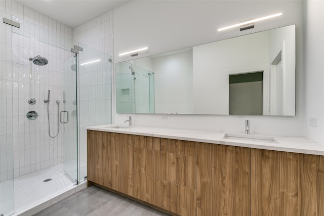 bathroom with vanity, wood-type flooring, and a shower with door