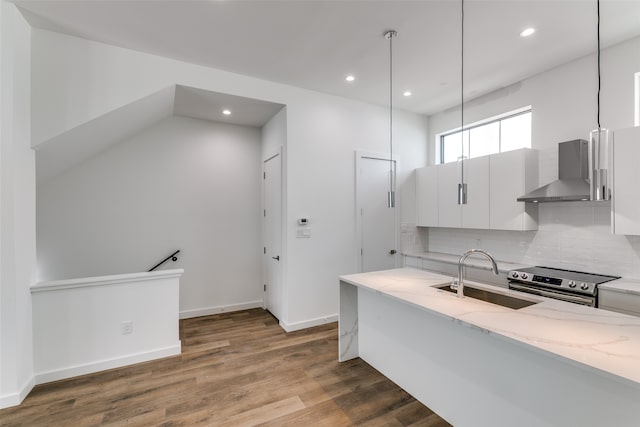 kitchen featuring sink, stainless steel range with electric cooktop, dark hardwood / wood-style flooring, white cabinetry, and wall chimney exhaust hood