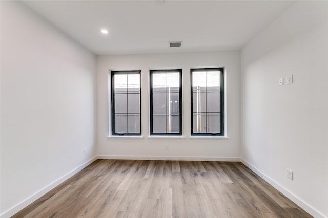 empty room with light hardwood / wood-style floors