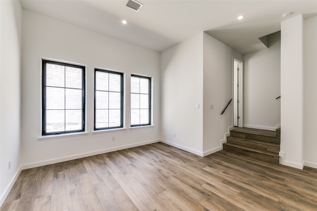 unfurnished room featuring wood-type flooring and a wealth of natural light