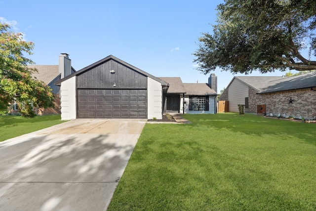 view of front of property with a front yard and a garage