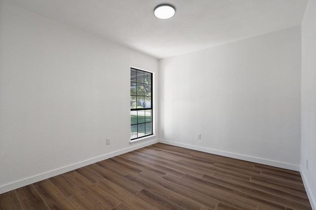 unfurnished room with dark hardwood / wood-style floors