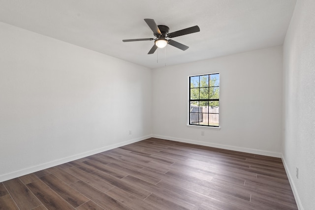 unfurnished room featuring ceiling fan and dark hardwood / wood-style flooring