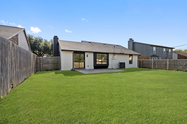 rear view of property with a patio, central AC, and a lawn