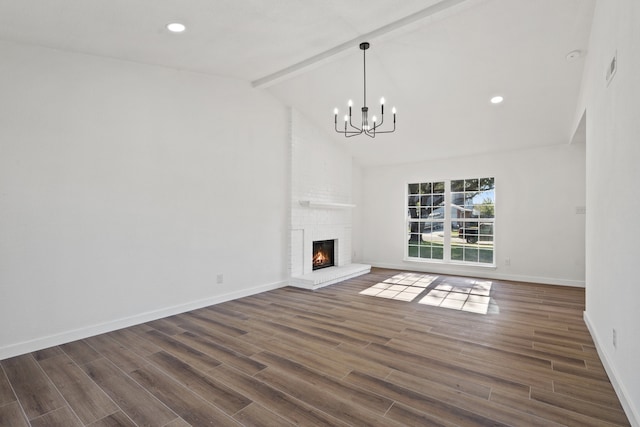 unfurnished living room featuring dark hardwood / wood-style floors, beamed ceiling, a brick fireplace, a chandelier, and high vaulted ceiling