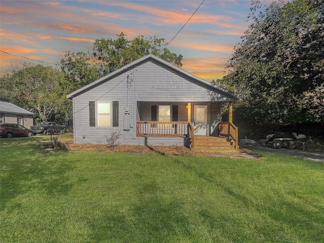 view of front of home featuring a lawn and a porch