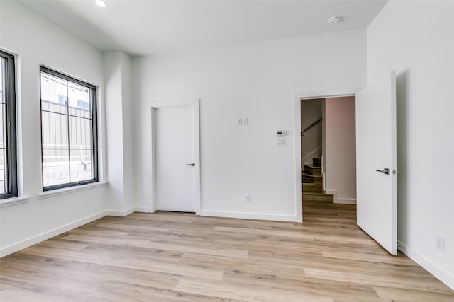 empty room with light hardwood / wood-style flooring