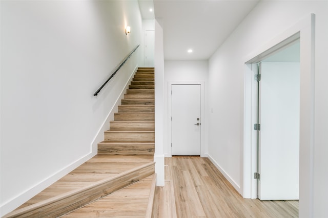 stairs featuring wood-type flooring