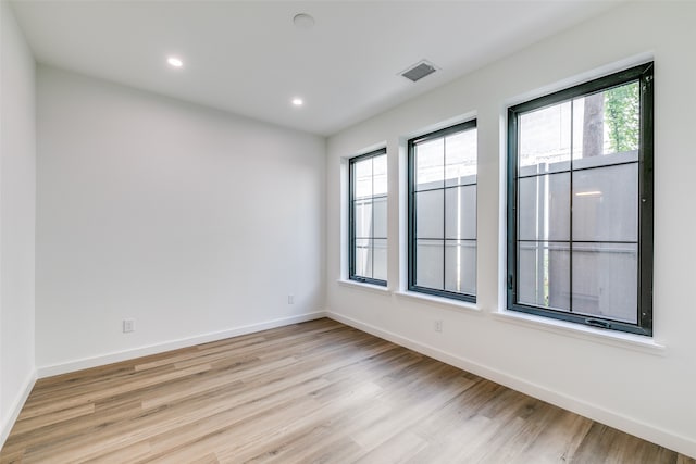 spare room with light hardwood / wood-style flooring and a wealth of natural light