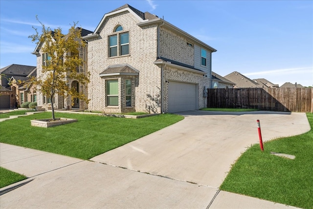 view of front of property with a front lawn and a garage