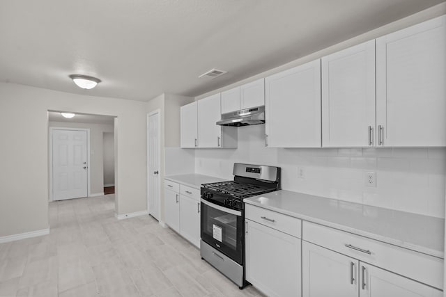 kitchen with backsplash, stainless steel range with gas cooktop, and white cabinets