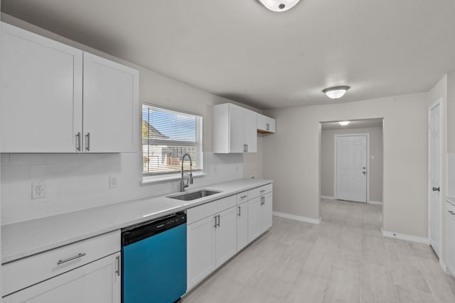 kitchen featuring dishwasher, white cabinets, and sink