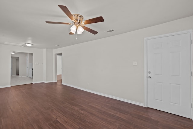 unfurnished room with dark hardwood / wood-style floors and ceiling fan