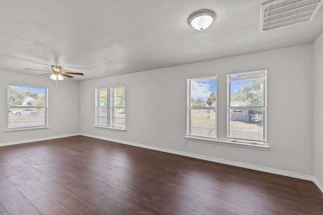 unfurnished room featuring a textured ceiling, ceiling fan, and dark hardwood / wood-style flooring