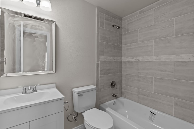 full bathroom featuring toilet, tiled shower / bath combo, and vanity