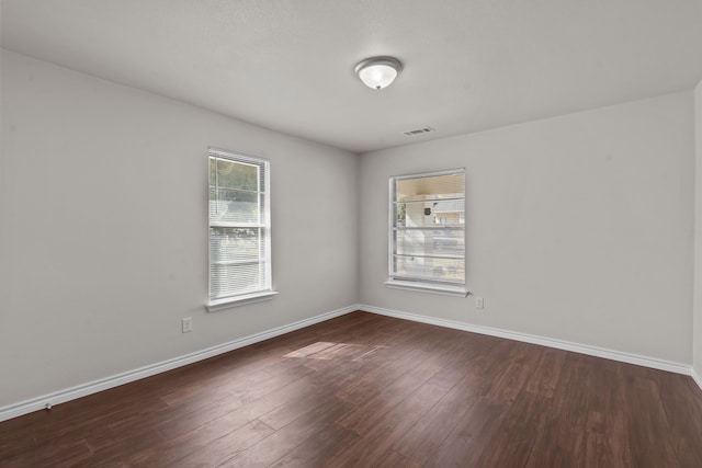 spare room featuring dark wood-type flooring