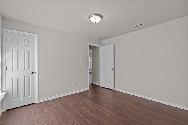 unfurnished bedroom featuring dark hardwood / wood-style floors