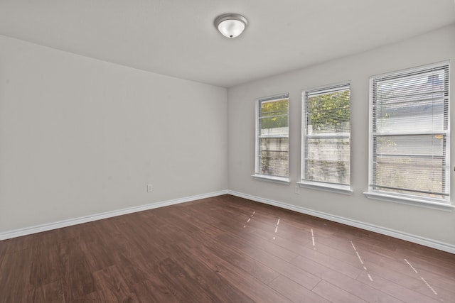 spare room with dark hardwood / wood-style floors