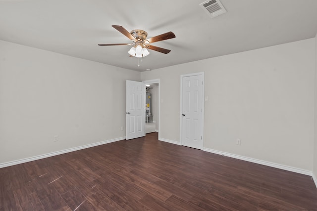 empty room featuring ceiling fan and dark hardwood / wood-style flooring