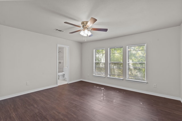 empty room with ceiling fan and dark hardwood / wood-style floors