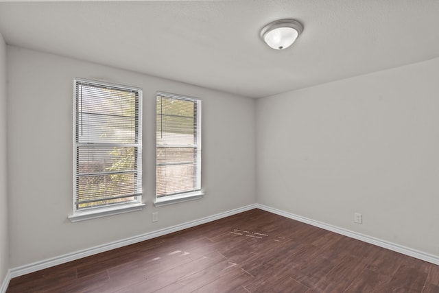 spare room with dark hardwood / wood-style flooring