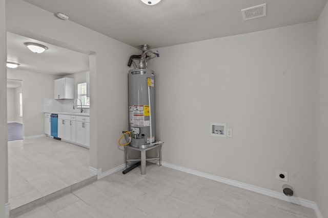 utility room featuring sink and gas water heater